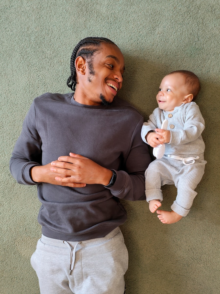 dad laying on floor next to baby